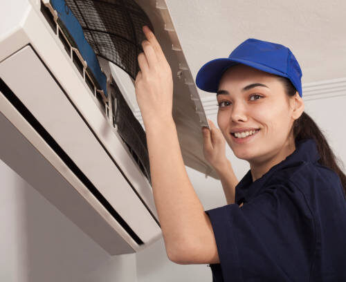 woman technician  repair an air conditioner