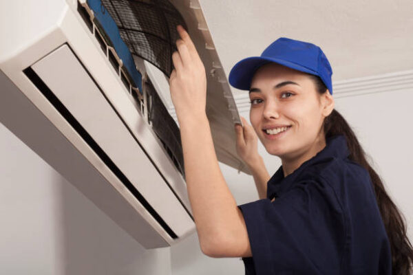 woman technician  repair an air conditioner