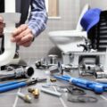 plumber at work in a bathroom, plumbing repair service, assemble and install concept