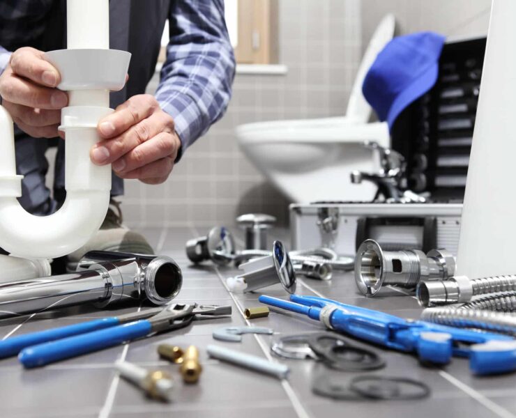 plumber at work in a bathroom, plumbing repair service, assemble and install concept